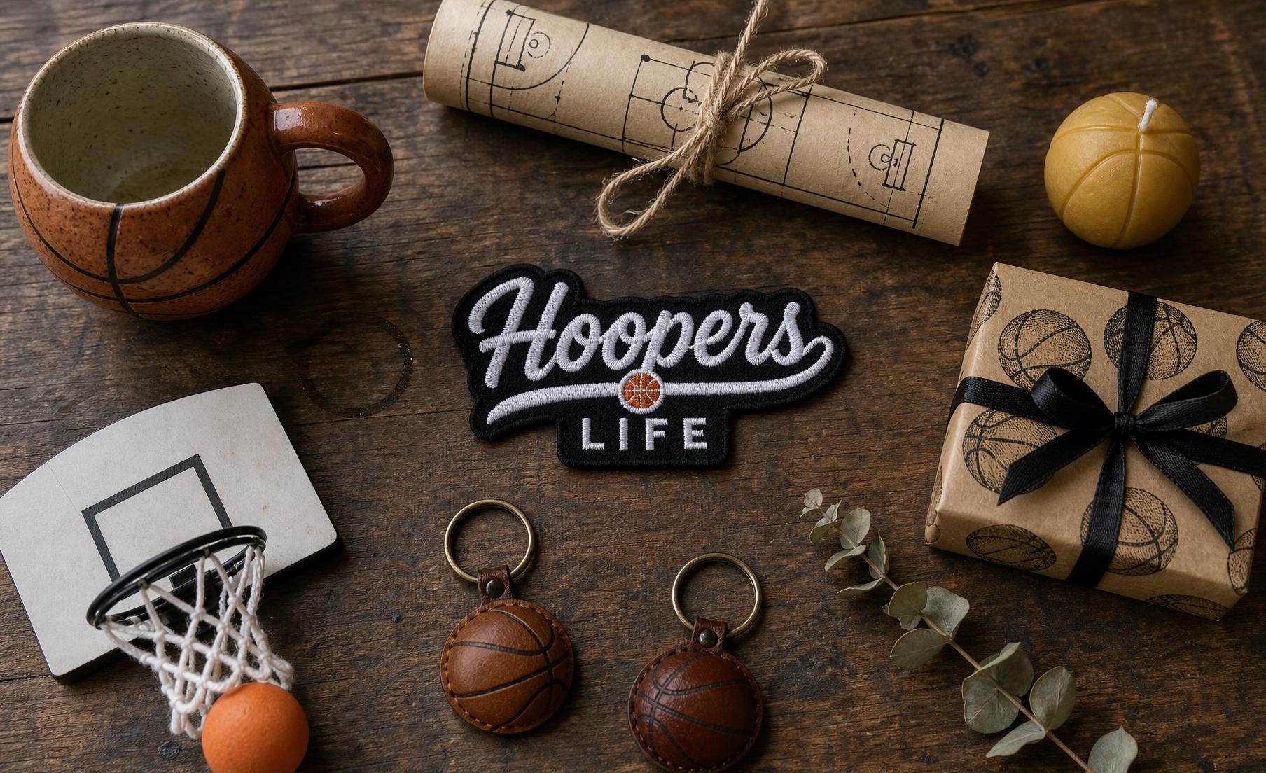 A vibrant flat lay of basketball gifts: a ball, mug, socks, candle, art prints and a wrapped box